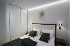 a bedroom with a bed with two pillows at Luxury Apartment Split in Split +20 photos