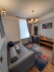 a living room with a couch and a kitchen at Number 8 in Canterbury