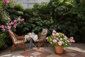a table and two chairs and flowers on a patio at Apartment & Rooms Primi with FREE PARKING in Dubrovnik