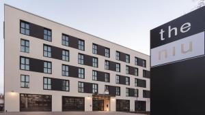 a large building with a sign in front of it at the niu Star - Apartments in Sindelfingen