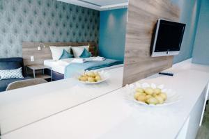 a hotel room with two beds and a tv at Haus am See Luxury HS 947 in Hahnenklee-Bockswiese
