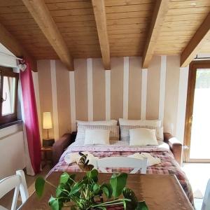 - une chambre avec un lit et un plafond en bois dans l'établissement LissaHouse Agriturismo, à San Pietro Vara