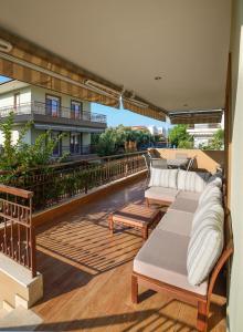 a row of chaise lounges on a balcony at Botanica Villas & Apartments in Neos Marmaras