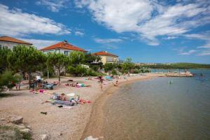 a group of people on a beach near the water at Apartment in Klimno/Insel Krk 12467 in Klimno