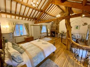 a bedroom with a large bed in a building at The Tree House Cumbria in Beckermet