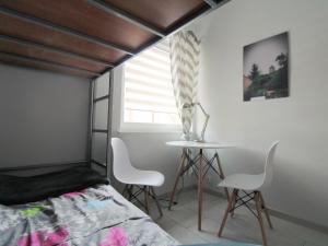 a bedroom with a bed and a table and chairs at Marina Santok in Santok