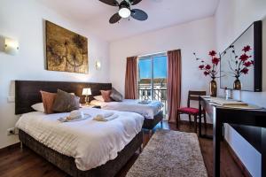 a hotel room with two beds and a desk at Fuseta Apartments - Bela Vista & Vista Mar - Penthouses in Fuzeta +63 photos