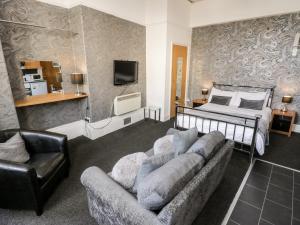 a living room with a bed and a couch at Mowbray 2 in Bridlington