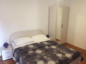 a small bedroom with a bed and a mirror at Katarina Rooms in Dubrovnik
