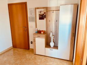 a room with a door and a vase on a shelf at Apartments Brnada in Umag