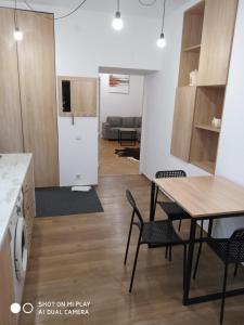 a kitchen and living room with a table and chairs at Gogol 14 Апартаменти в історичному центрі міста in Uzhhorod