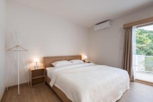 Postel nebo postele na pokoji v ubytování COROOM BKK