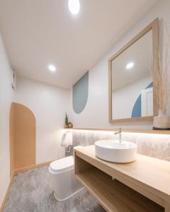 a bathroom with a sink and a toilet at COROOM BKK in Bangkok