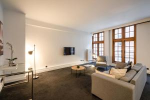 a living room with a couch and a tv at Smartflats - Grand-Place I in Brussels