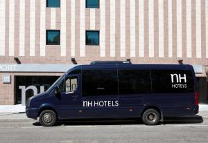 a blue van parked in front of a building at NH Barajas Airport in Madrid