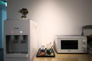 a kitchen with a microwave and a coffee maker at Hotel Irene City in Seoul