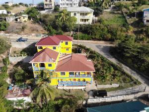 an overhead view of a yellow house with a roof at Bay View Studio Apartment 3B - Canouan Island in Canouan