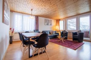 a living room with a table and chairs and a couch at Miraflor Angela by Arosa Holiday in Arosa