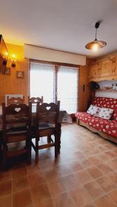 a bedroom with a table and chairs and a bed at Le coeur des Memises in Thollon
