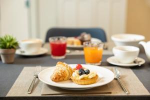 a table with a plate of breakfast foods on it at Hotel La Caporala in Castel d'Azzano