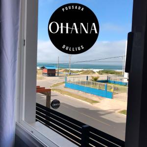a window with a view of the ocean at Pousada Ohana Dullius in São Francisco do Sul