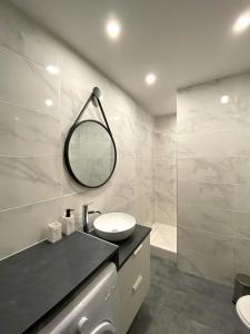 a white bathroom with a sink and a mirror at Appartement chic et cosy au pied du village in Villard-de-Lans