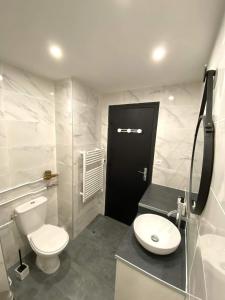 a white bathroom with a toilet and a sink at Appartement chic et cosy au pied du village in Villard-de-Lans