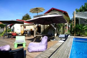 a swimming pool with chairs and umbrellas next to a swimming pool at The Secret Spot Lodge in Azur