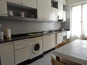 a kitchen with a washing machine and a table at Poggio dei sogni in Rapallo +9 photos
