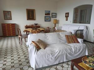 a living room with a white couch and a table at Poggio dei sogni in Rapallo