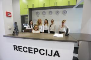 a group of people standing behind a reception desk at Hostel Moving in Zagreb