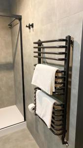 a towel rack in a bathroom with a shower at Zajazd Valentino / Listopadowa 55 in Tomaszów Lubelski