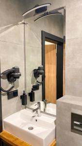 a bathroom with a white sink and a mirror at Zajazd Valentino / Listopadowa 55 in Tomaszów Lubelski