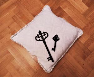 a white pillow with a cross on it on a wooden floor at Villa Tethys Mountain Resort in Zákas