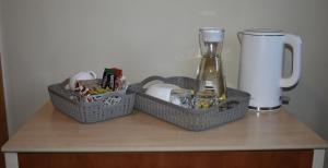two baskets on a table with a bottle of wine at Guest House Gero Vėjo Namai in Klaipėda