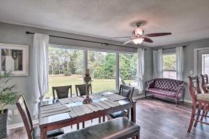 a dining room with a table and a ceiling fan at Deltona Lake House, Day Trip to Disney and Universal in Deltona