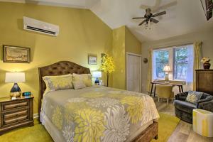 a bedroom with a bed and a chair and a fan at 13 Mi to Camelback Ski! Creekside Lincoln Lodge in Brodheadsville