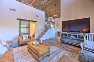 a living room with a fireplace and a large tv at Cabin 404 - Payson Getaway with Deck and Mtn Views! in Payson