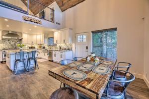 a large kitchen with a wooden table and chairs at Cabin 404 - Payson Getaway with Deck and Mtn Views! in Payson
