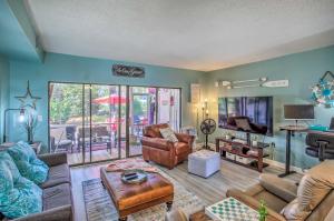 a living room with a couch and a table at Coastal Escape with Balcony and Grill Less Than 2 Mi to Beach! in Myrtle Beach