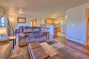 a living room with a couch and a kitchen at Steamboat Home with Garage, 1 Mi to Ski Resort in Steamboat Springs