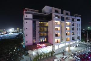 a hotel building with a sign on it at night at The Contour Hotel in Guwahati