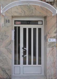 a front door of a building with a gate at Hostal La Pilarica in Paterna