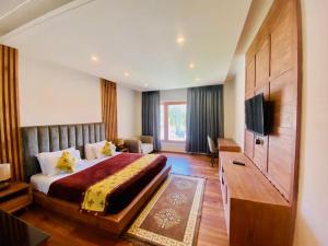 a hotel room with a bed and a television at Ladakh Himalayan Retreat in Leh