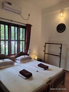 Katil atau katil-katil dalam bilik di Neela Waters - Beach Home