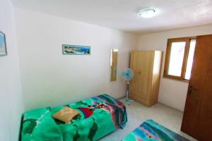 A bed or beds in a room at Appartamenti Leuca 50 m dal mare