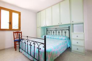 A bed or beds in a room at Appartamenti Leuca 50 m dal mare