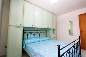 A bed or beds in a room at Appartamenti Leuca 50 m dal mare