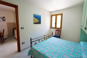A bed or beds in a room at Appartamenti Leuca 50 m dal mare