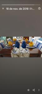 a table with blue vases and plates on it at A Casa Bella - Guesthouse in Ilhabela